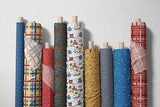 a row of colorful cloths hanging on a wall