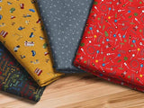 a bunch of different colored fabric on a wooden floor