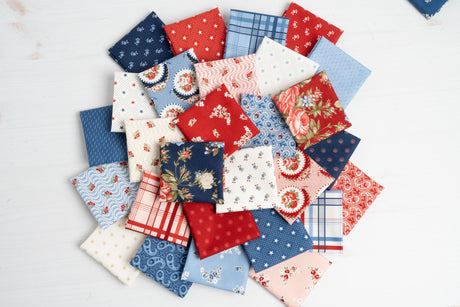 a pile of different types of fabric on a table