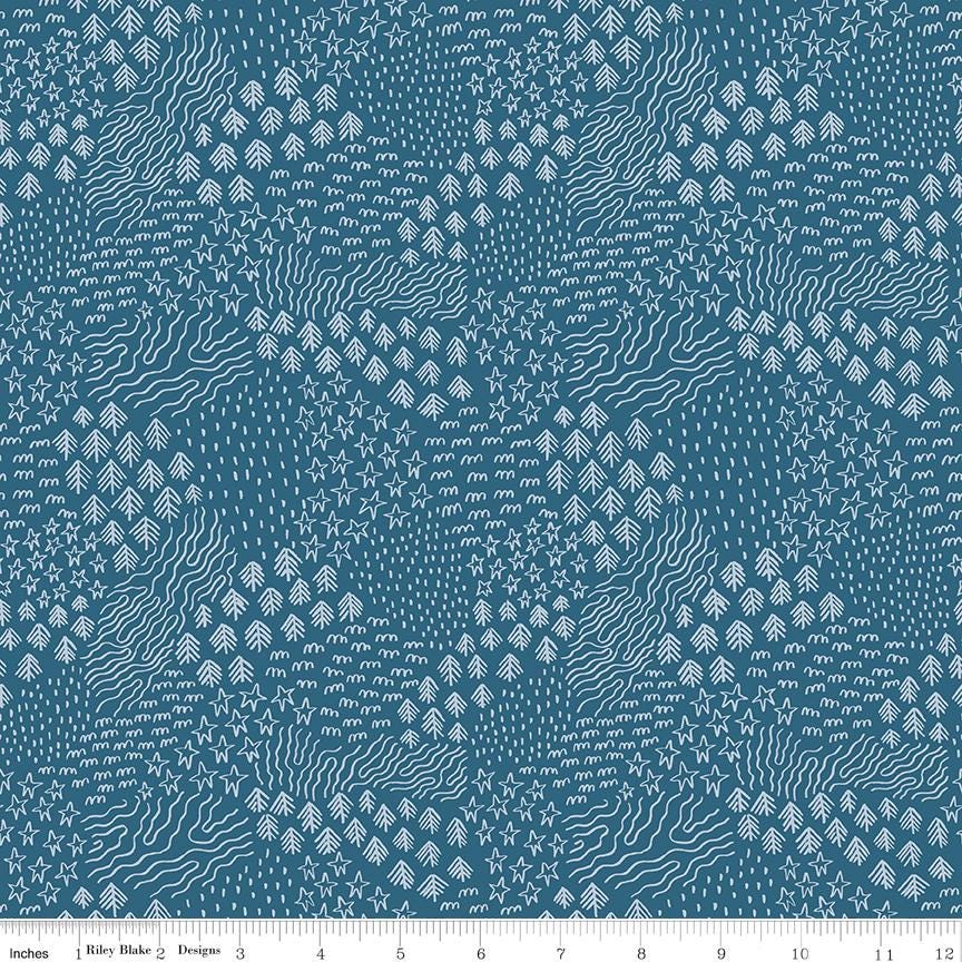 a blue and white pattern with a ruler in front of it