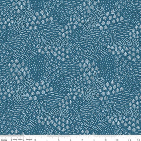 a blue and white pattern with a ruler in front of it