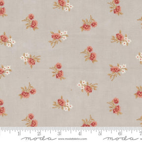 a white and pink flowered fabric with a ruler in front of it
