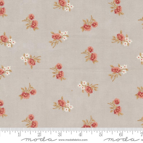 a white and pink flowered fabric with a ruler in front of it