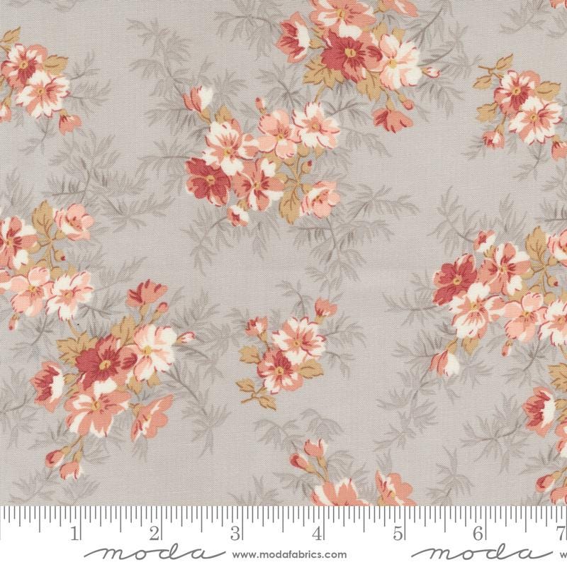 a flowered fabric with pink and yellow flowers on a gray background