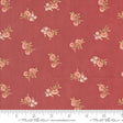 a red fabric with pink flowers on it
