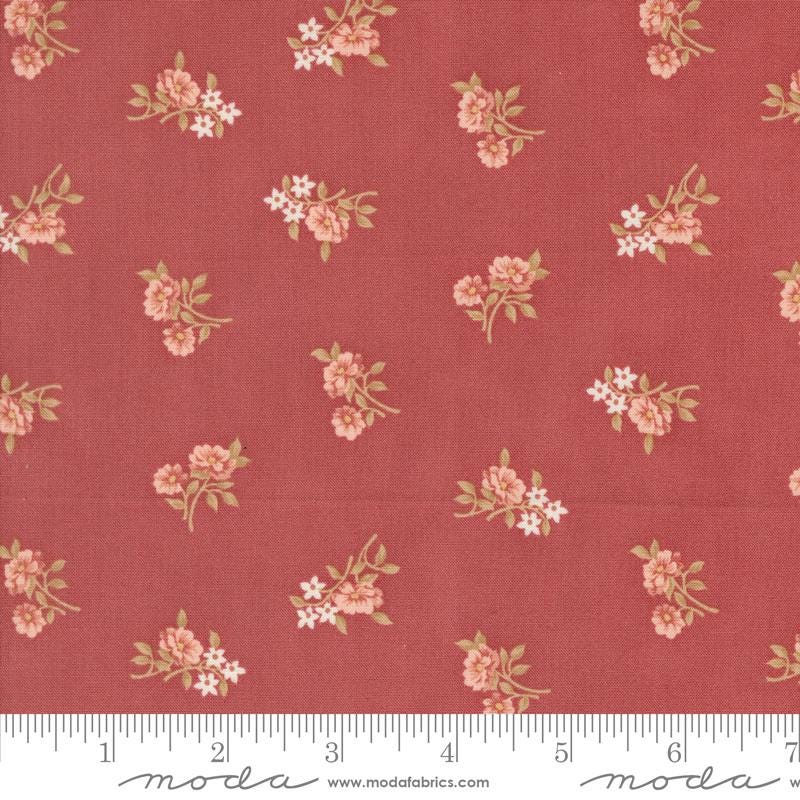 a red fabric with pink flowers on it
