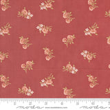 a red fabric with pink flowers on it