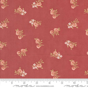 a red fabric with pink flowers on it