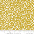 a yellow fabric with white leaves on it