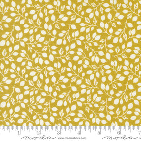 a yellow fabric with white leaves on it