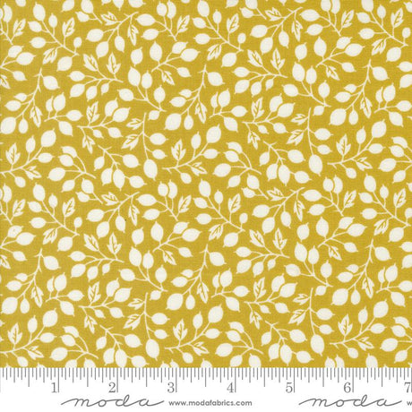 a yellow fabric with white leaves on it
