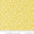 a yellow fabric with white leaves on it