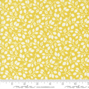 a yellow fabric with white leaves on it
