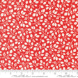 a red fabric with white leaves on it