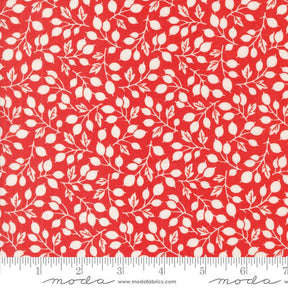 a red fabric with white leaves on it