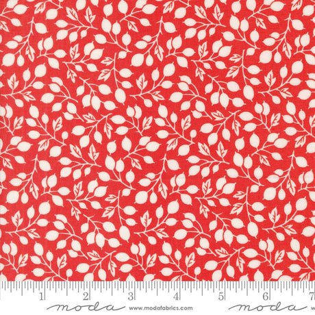 a red fabric with white leaves on it