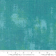 a ruler is next to a green background
