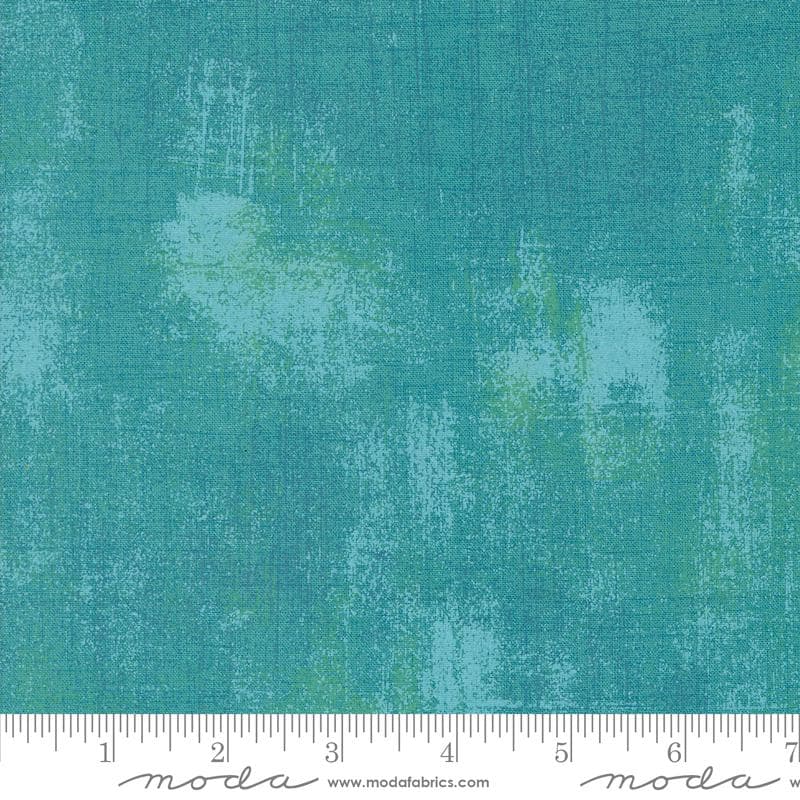 a ruler is next to a green background