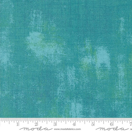 a ruler is next to a green background