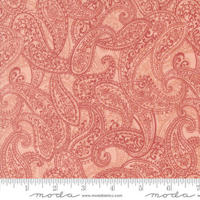 a red paisley print fabric with a ruler