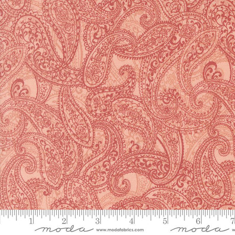 a red paisley print fabric with a ruler