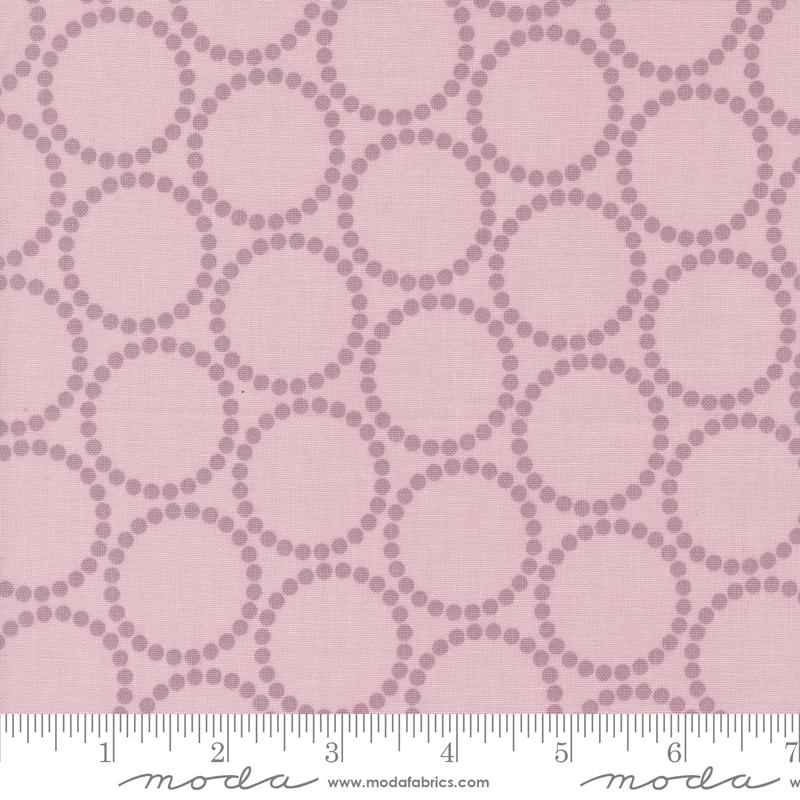 a pink background with circles and dots