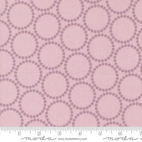 a pink background with circles and dots