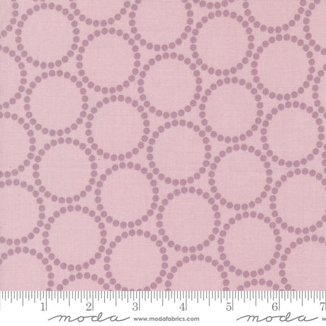 a pink background with circles and dots