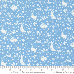 a blue background with white rabbits and mushrooms
