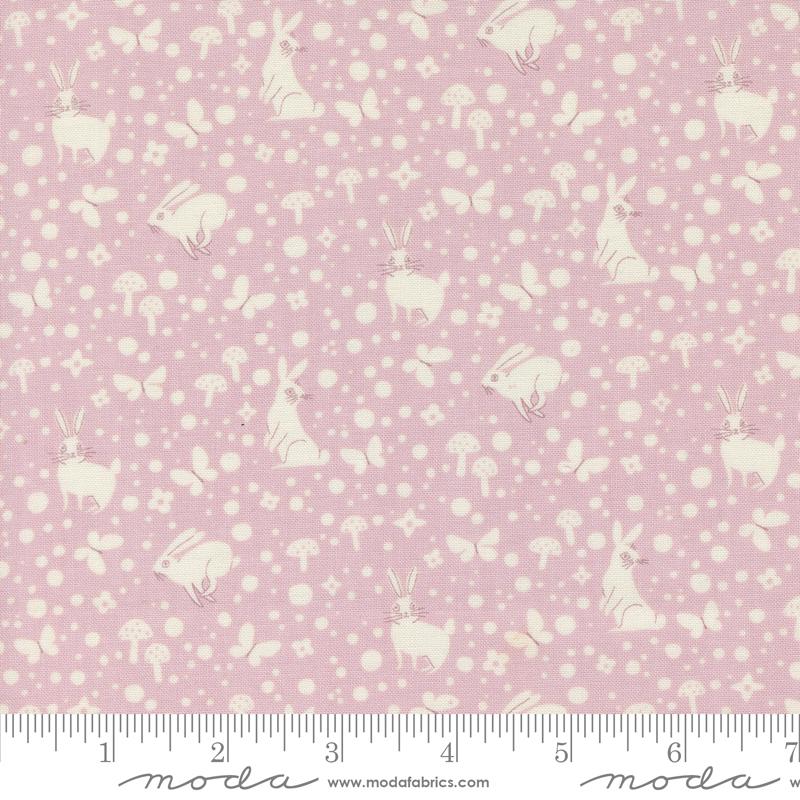 a pink and white fabric with white polka dots