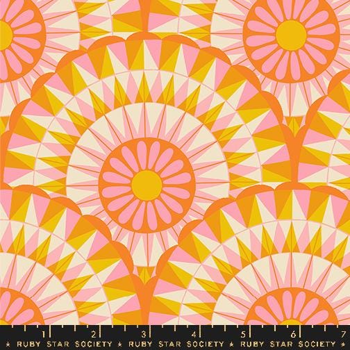 an orange and pink pattern with a ruler in front of it
