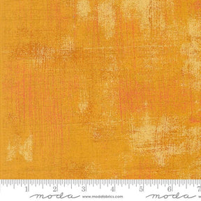 a yellow background with a ruler in front of it