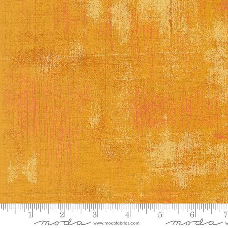 a yellow background with a ruler in front of it
