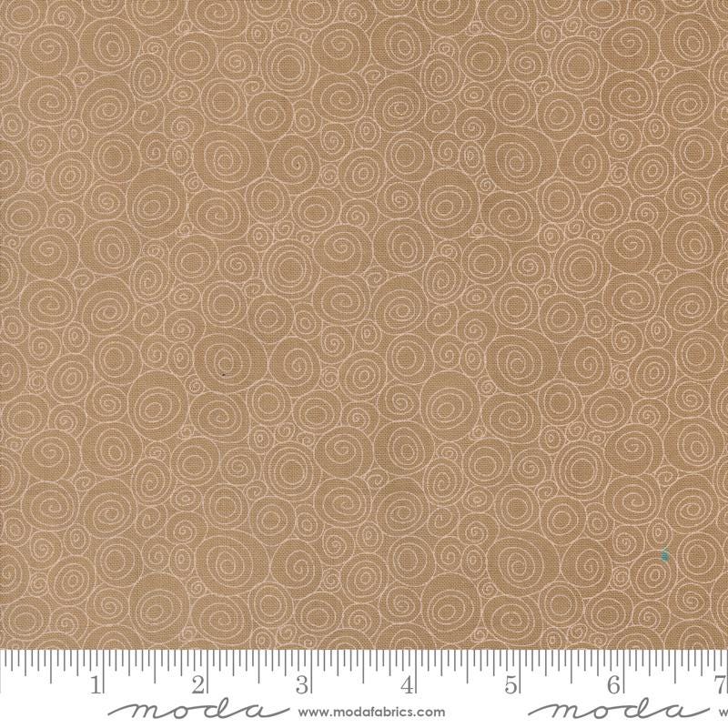 a ruler is next to a brown background