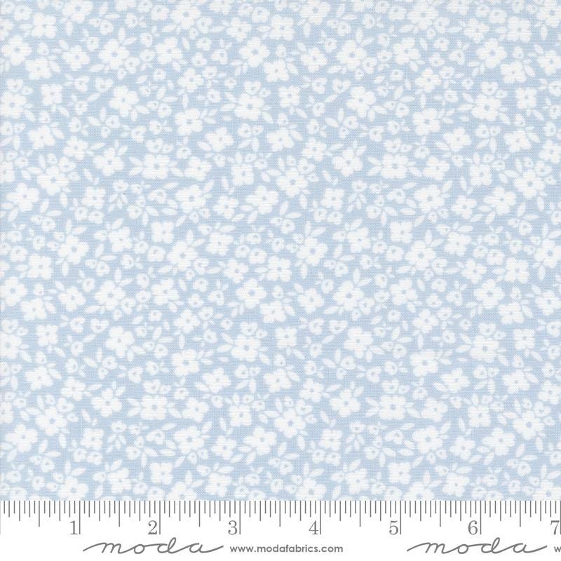 a white and blue flower pattern on a light blue background