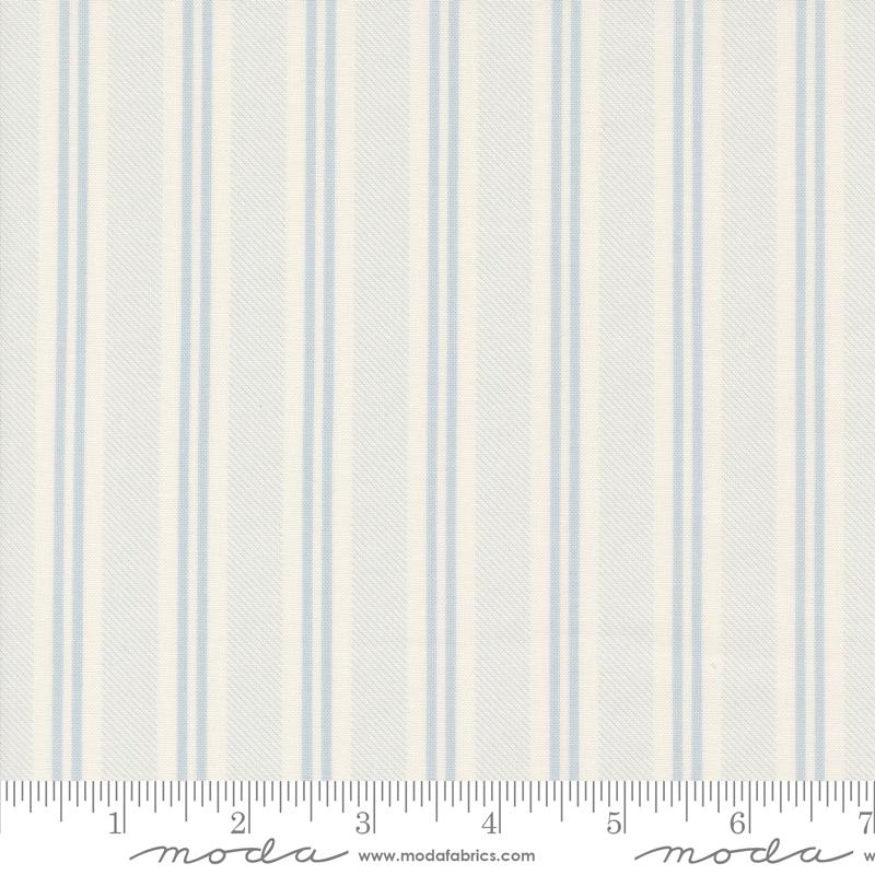 a white and blue striped wallpaper with a ruler