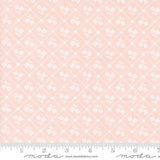 a pink background with white flowers on it