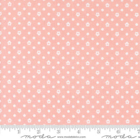 a pink fabric with white dots on it