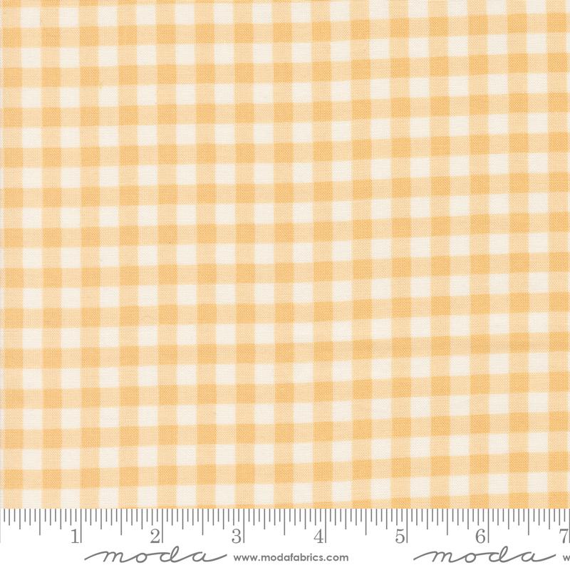 a yellow and white checkered fabric with a ruler