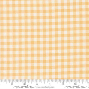 a yellow and white checkered fabric with a ruler