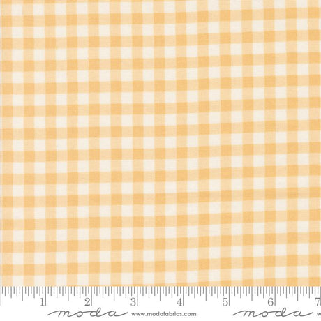 a yellow and white checkered fabric with a ruler