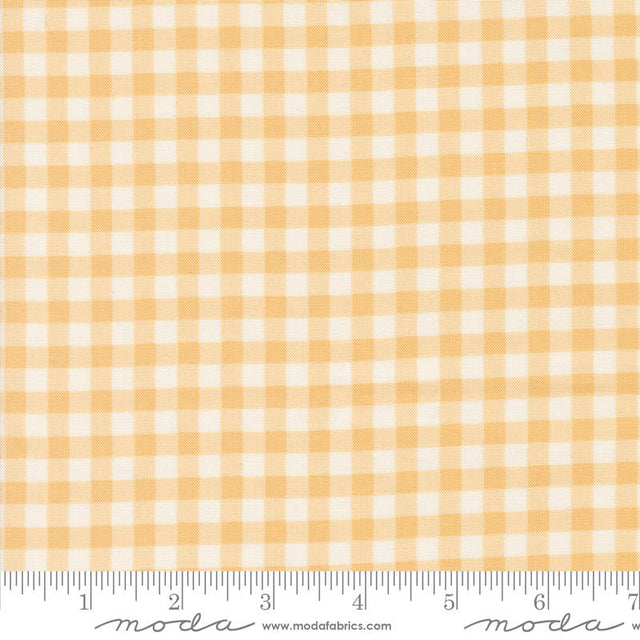 a yellow and white checkered fabric with a ruler