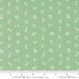 a green fabric with white flowers on it