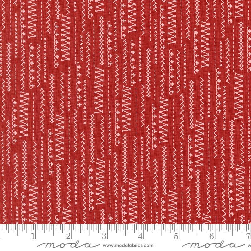 a ruler with a red and white pattern on it