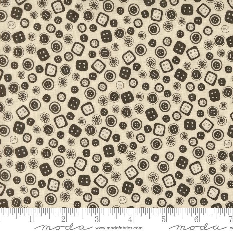 a white and brown pattern with black dots