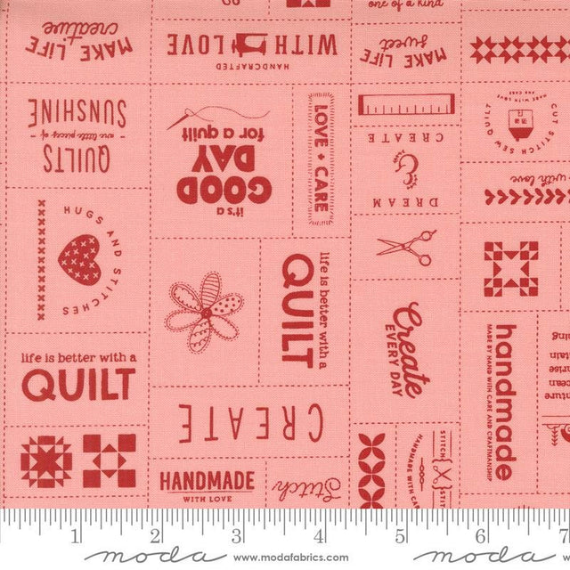 a pink fabric with red and white words on it