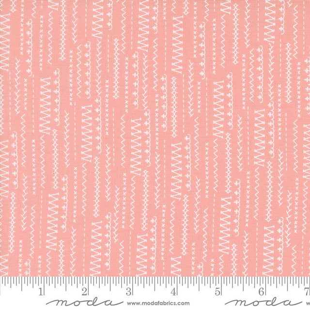 a ruler with a pink and white pattern on it