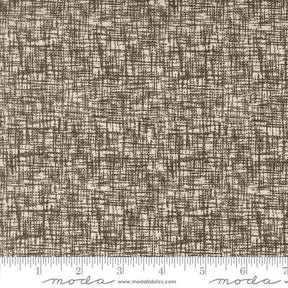 a brown and white textured fabric with a ruler