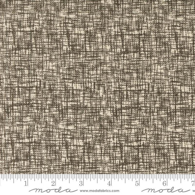 a brown and white textured fabric with a ruler