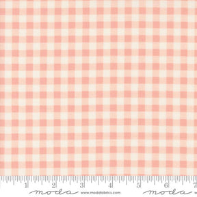 a pink and white checkered fabric with a ruler